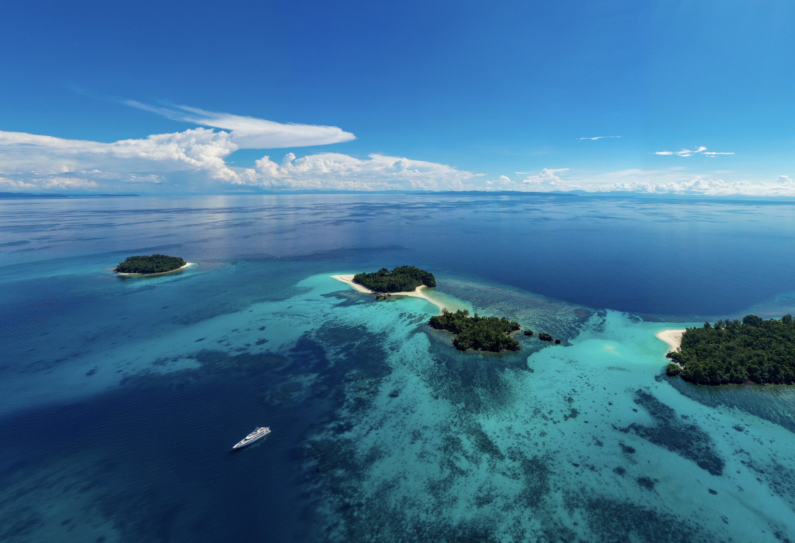 aerial-view-tropical-islands-and-yacht-cenderawasih-bay-west-papua