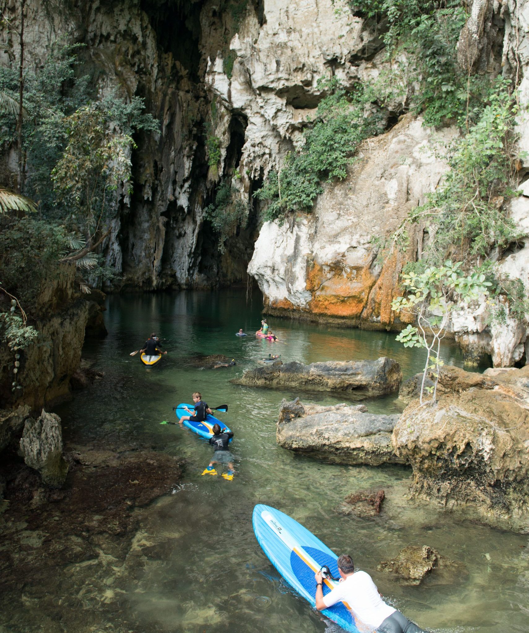 paddleboarders-exploring-limestone-cave-raja-ampat